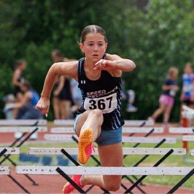 Girl running hurdle race